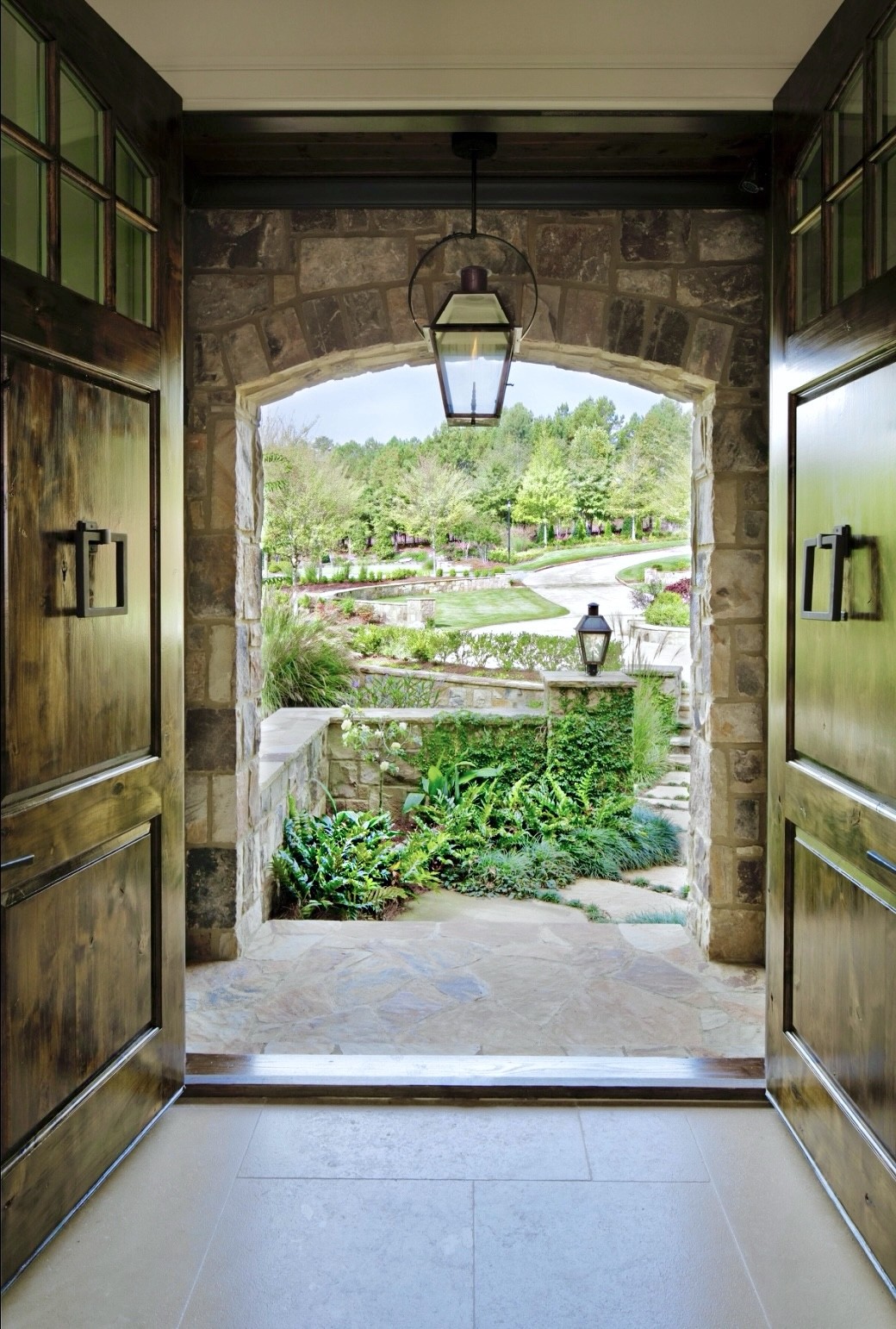Riverstone Custom Homes — arched stone entryway